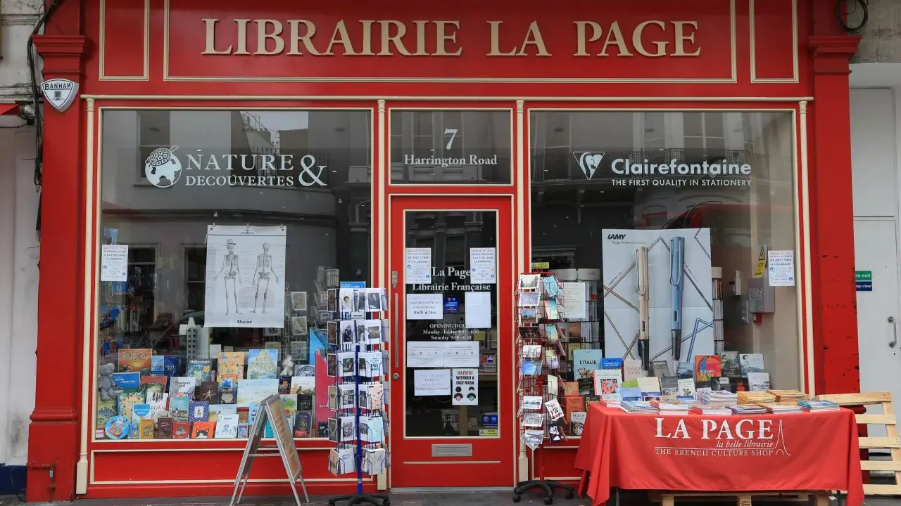 La librairie La Page, une maison d'édition premier roman, expose ses livres et cartes postales en vitrine.