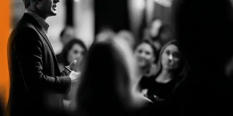 Un homme parle à une audience attentive. Je me souviens de cette conférence, c'était une expérience vécue marquante.