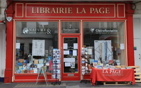 La librairie La Page, une maison d'édition premier roman, expose ses livres et cartes postales en vitrine.