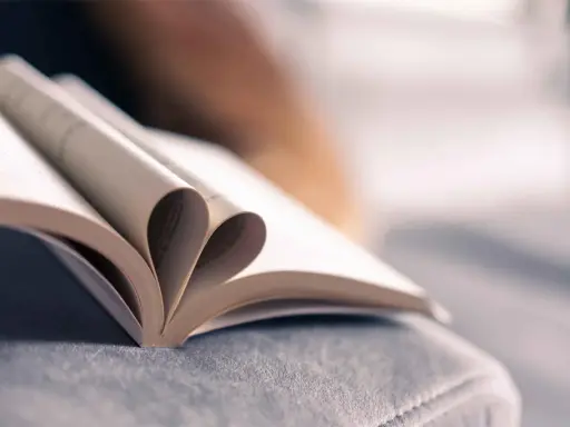 Un livre ouvert dont les pages forment un cœur, symbole de l'amour des mots et de la passion de la maison d'édition.